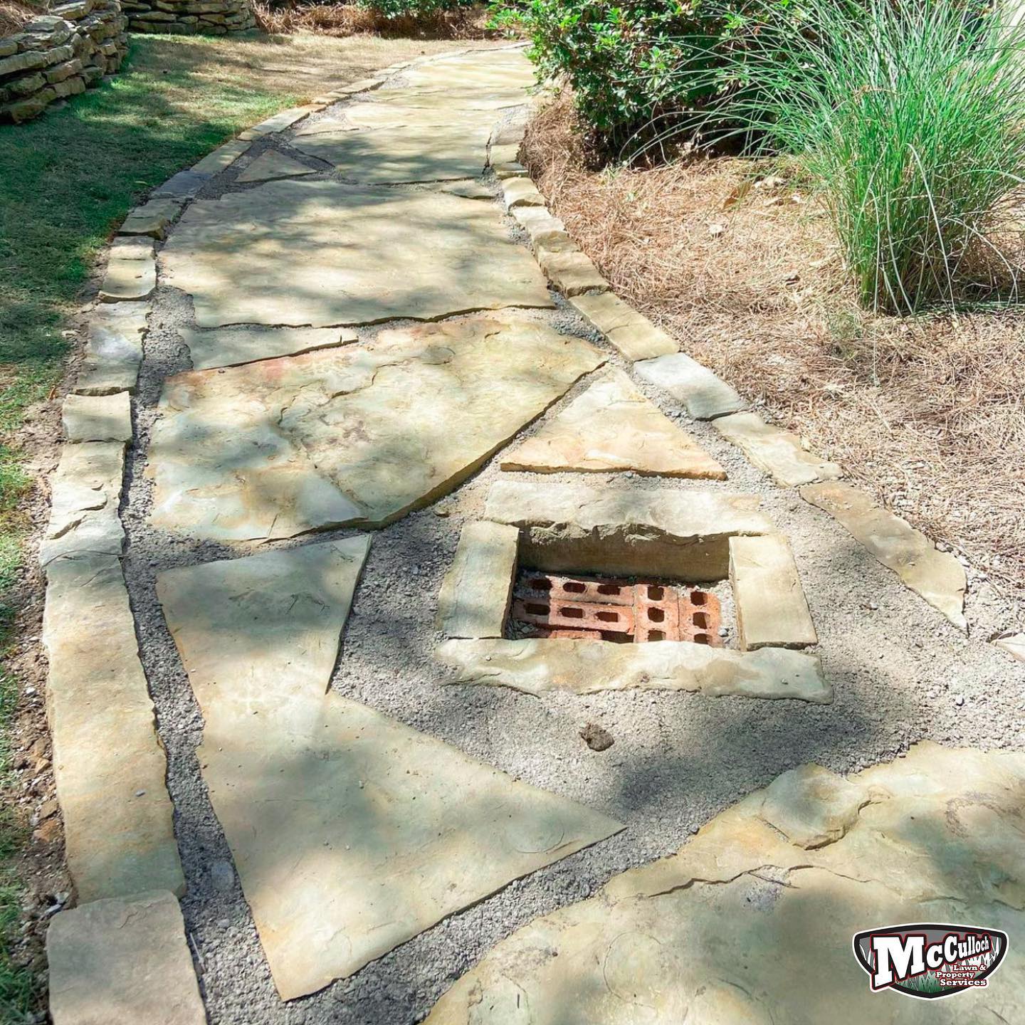 large rock rockway around sewer drain